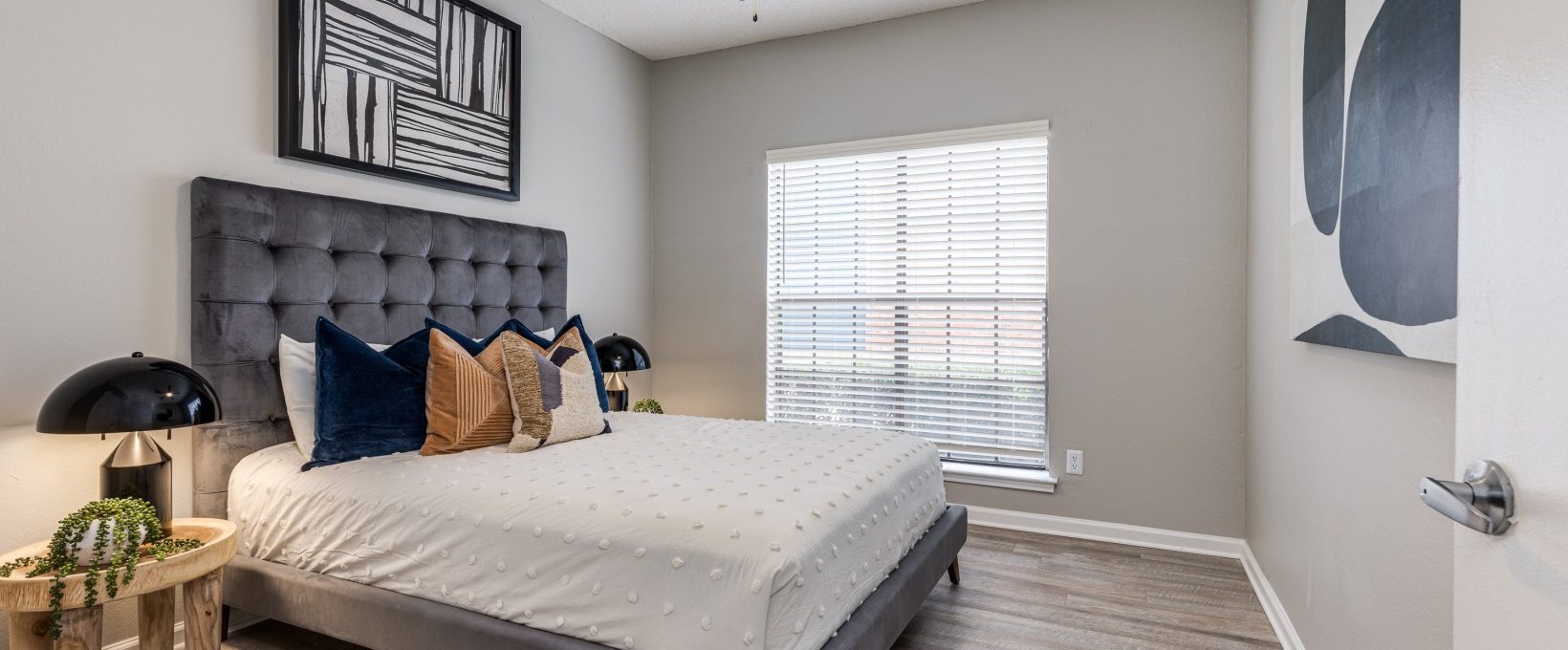a bedroom with a ceiling fan and hardwood floors at The  Dayton