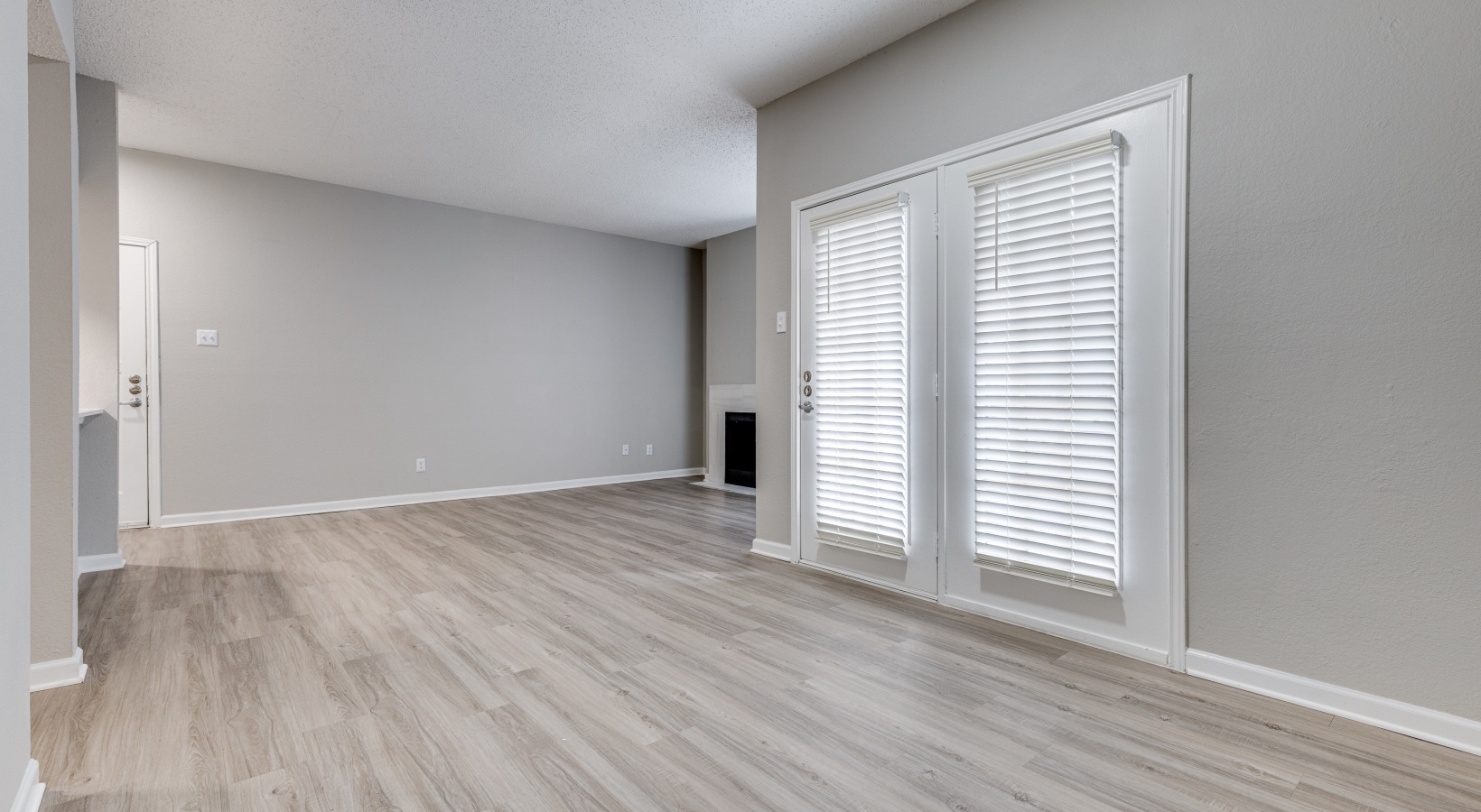 empty room with hardwood floors and sliding glass doors at The  Dayton