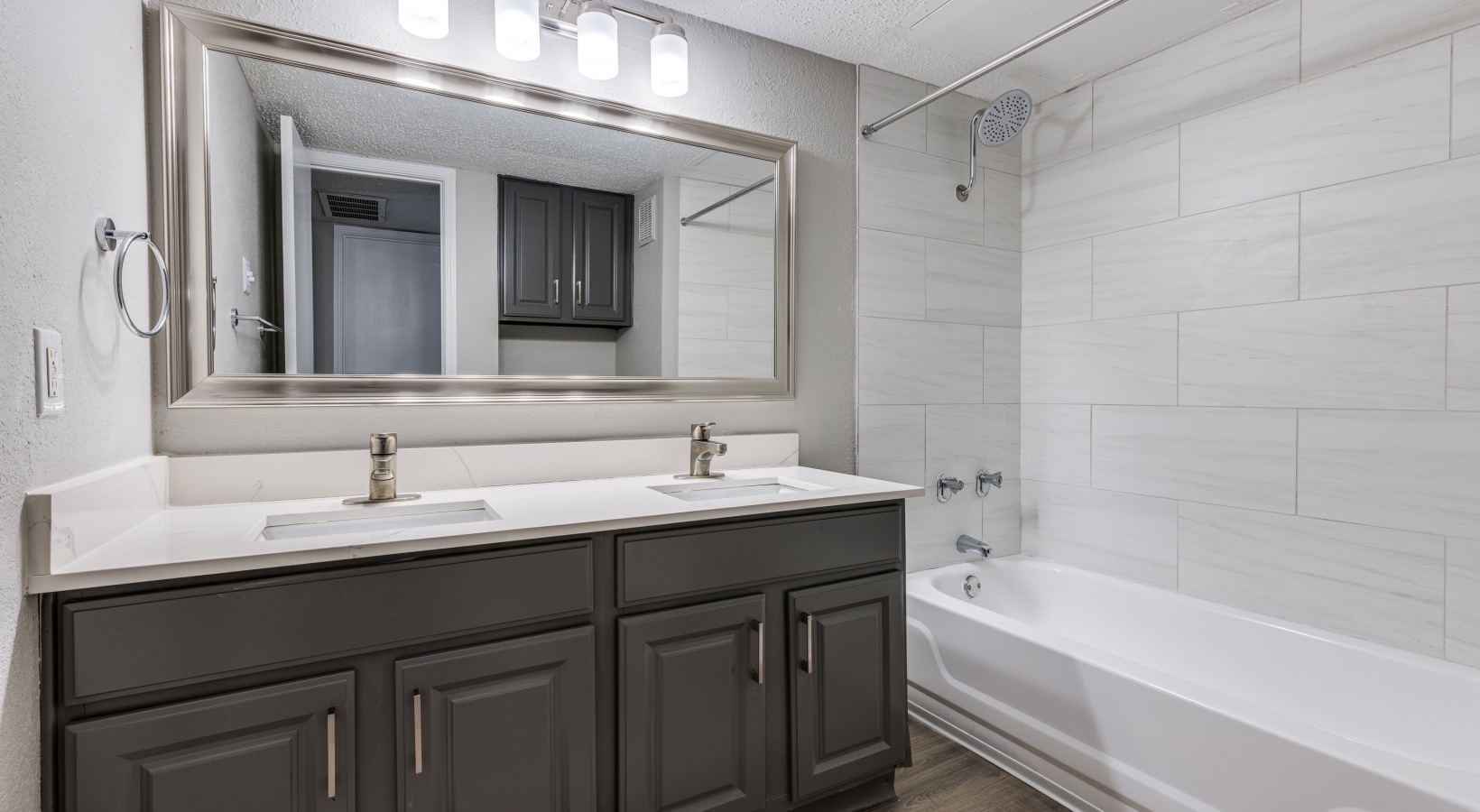 a bathroom with a white vanity and tub at The  Dayton