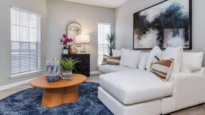 a living room with white furniture and blue rug at The  Dayton