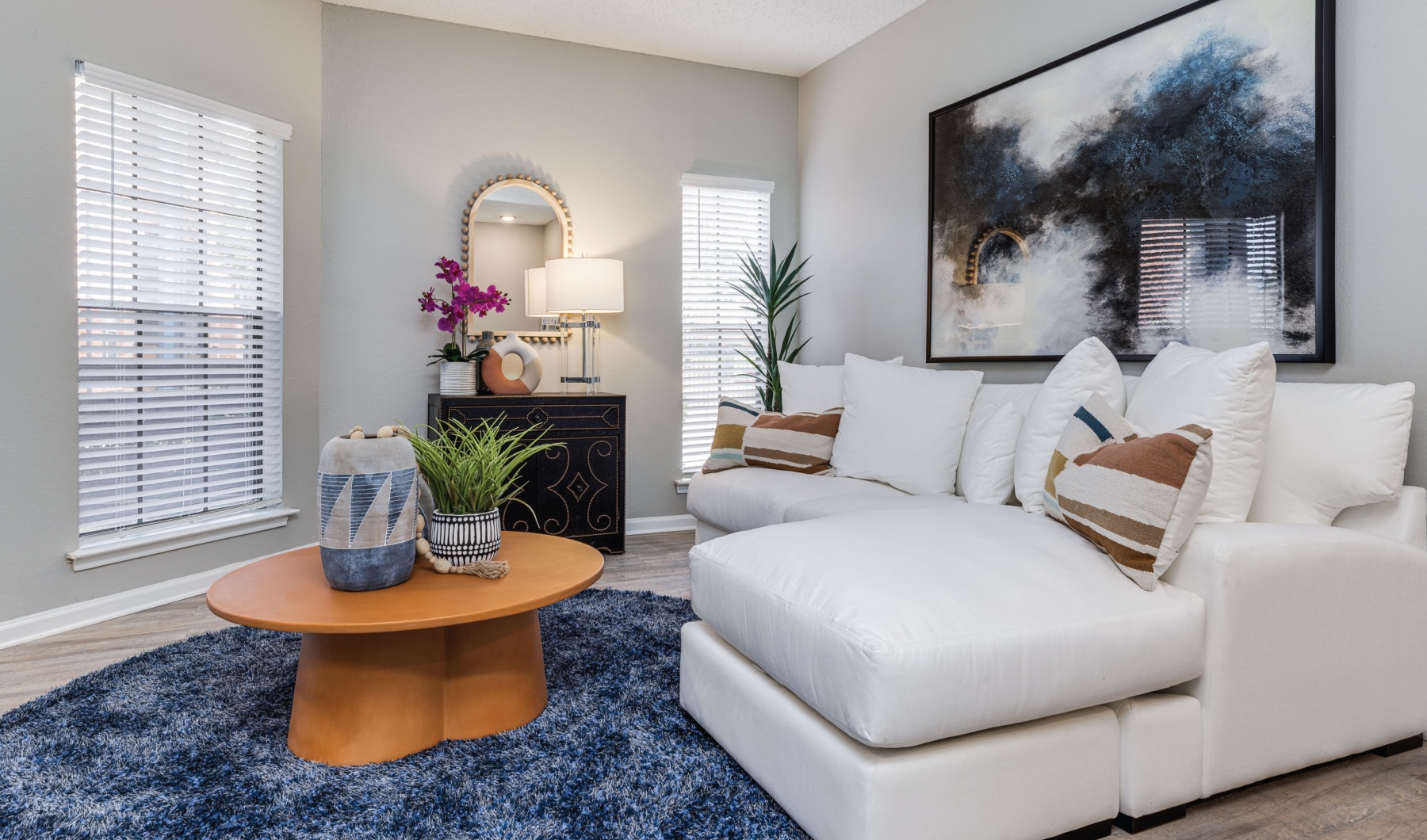 a living room with white furniture and blue rug at The  Dayton