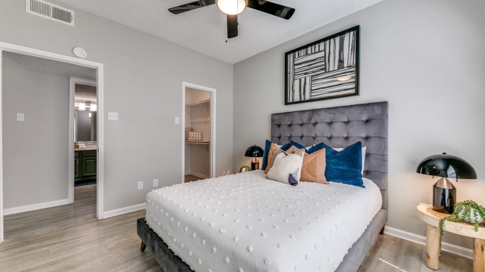 a bedroom with a ceiling fan and hardwood floors at The Dayton